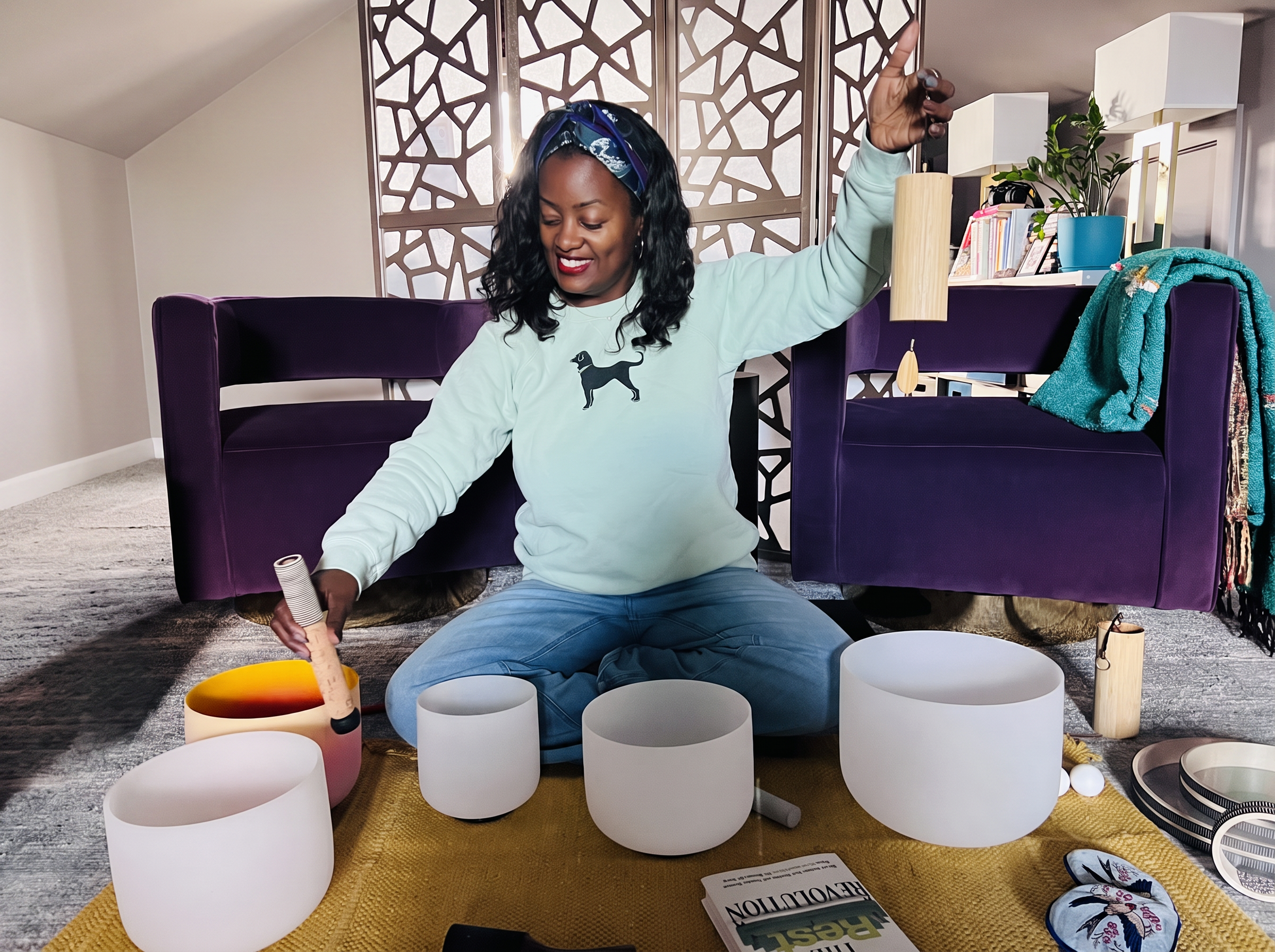 Amanda facilitating a sound bath experience with The Rest Revolution book